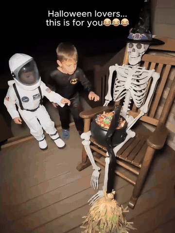 Animated witch broom moving across a Halloween display