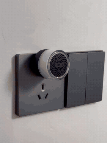 Wireless doorbell button being mounted and pressed while the indoor plug-in chime lights up