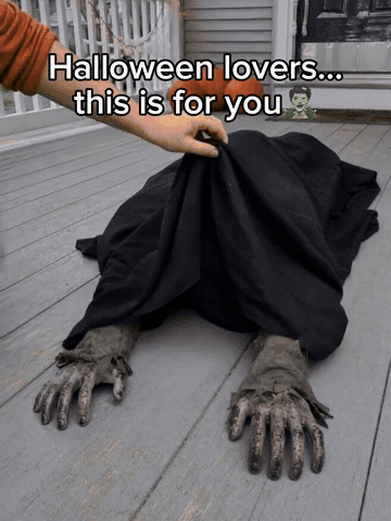 Crawling zombie Halloween prop surprising guests on a porch