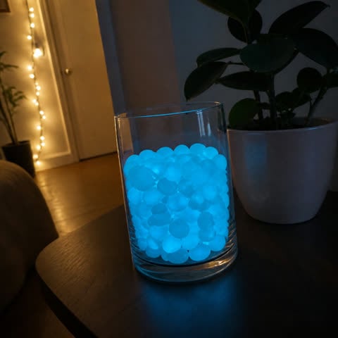 Blue glow pebbles arranged in a glass vase
