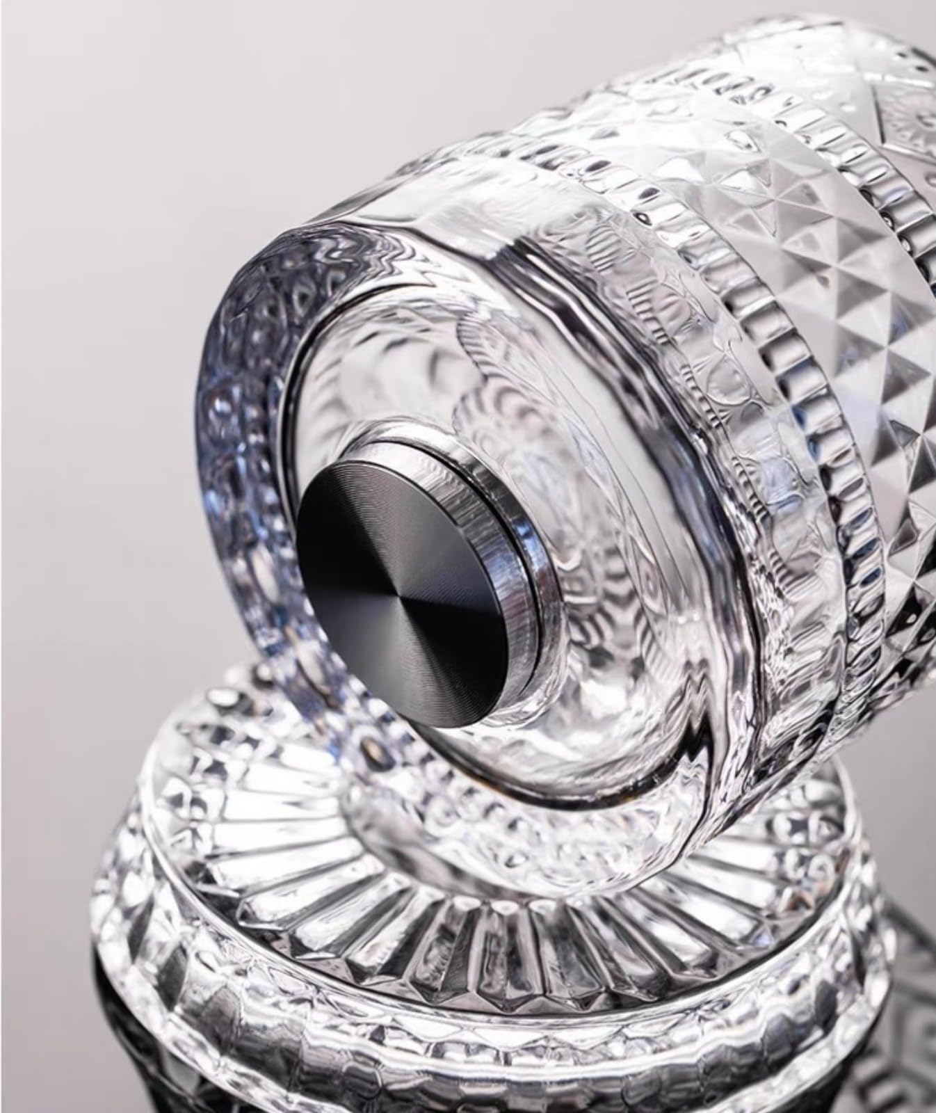 Close-up of the glass's base showing the spinning mechanism and crystal cutting