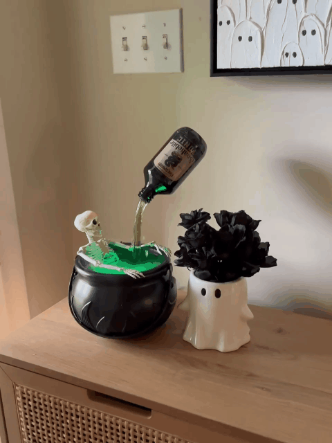 Magic floating potion bottle cauldron operating in a home Halloween display