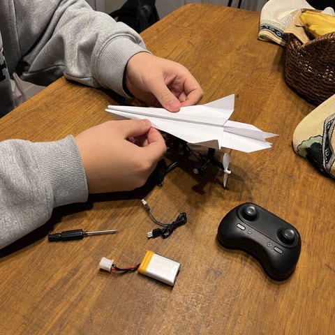 Assembling the paper airplane kit at home