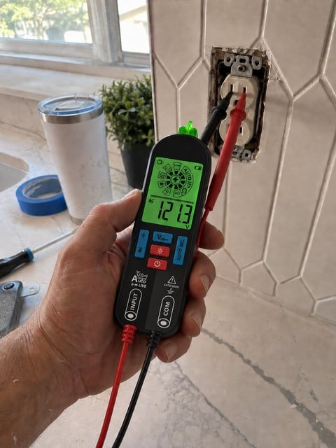 Smart pen multimeter used during a kitchen outlet renovation check