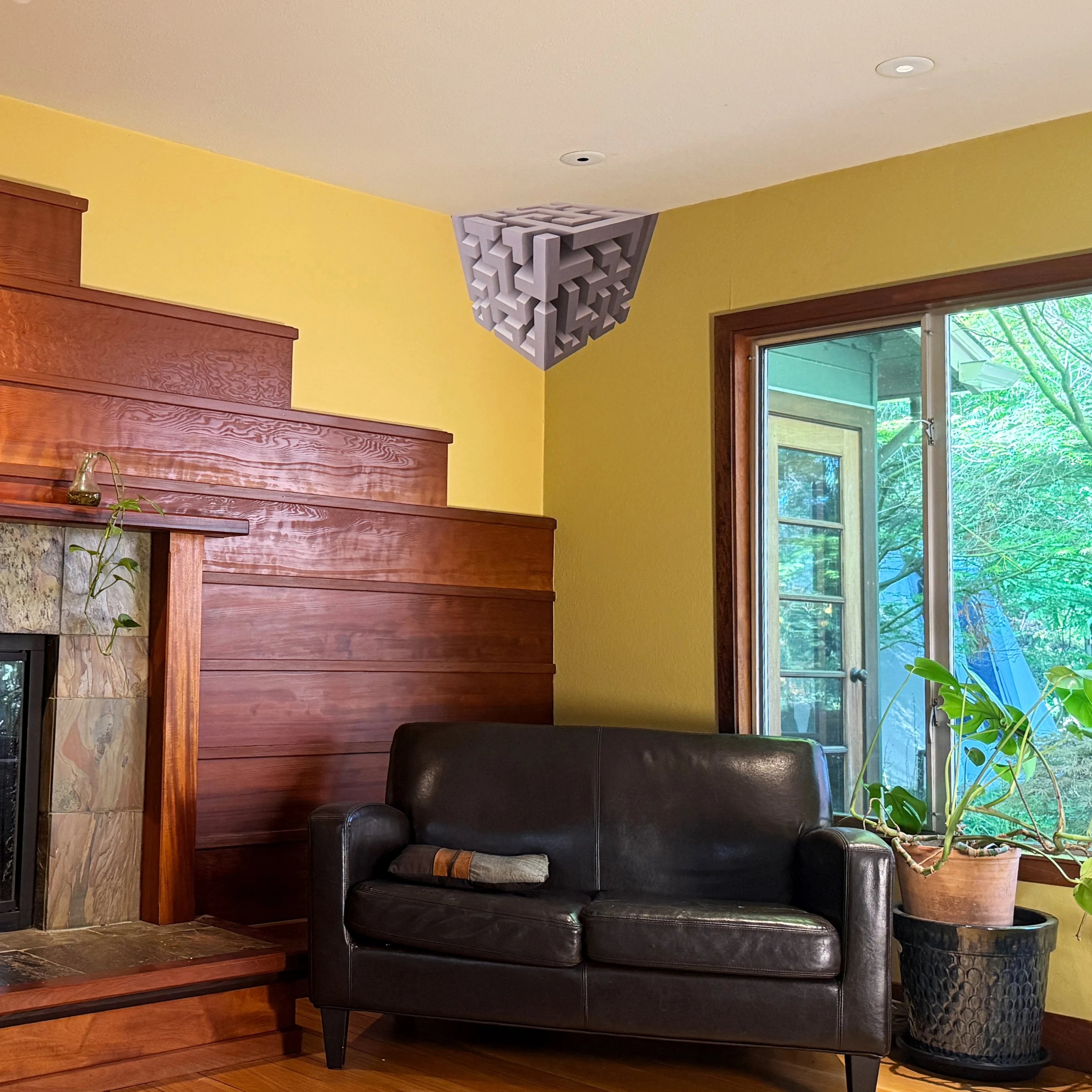 Living room with a black sofa, wooden staircase, and a geometric ceiling decoration.