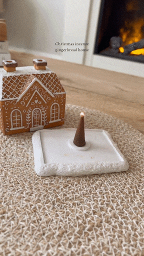 Incense smoke flowing through gingerbread house chimneys